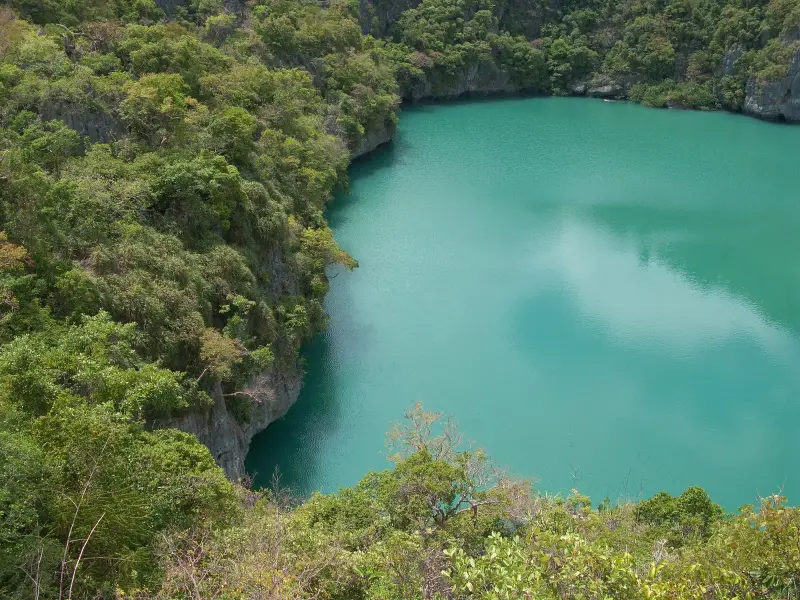 The emerald Thale Nai lagoon on Ko Mae Ko among limestone cliffs, seen from above