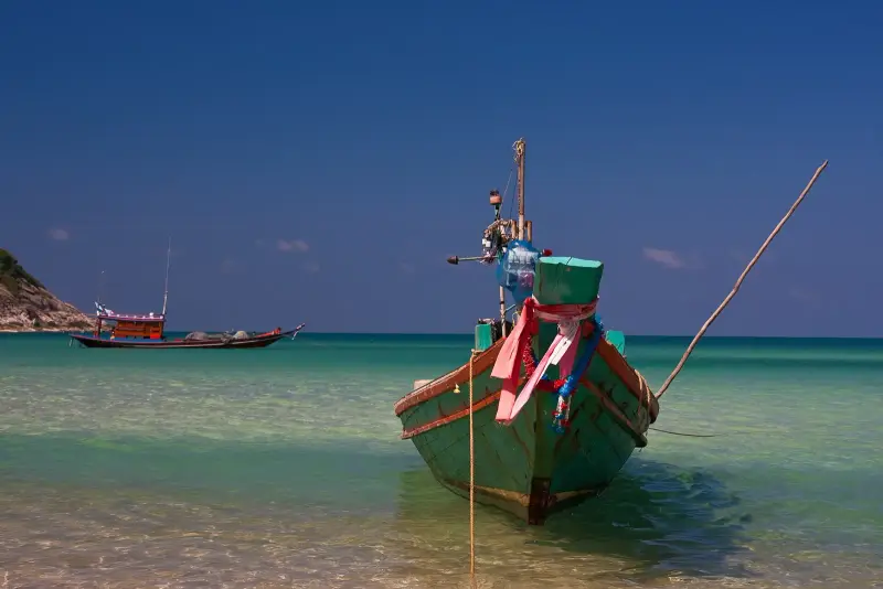 A fishing boat in clear water off Bottle Beach