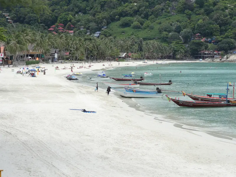 Haad Rin Nok beach with longtail boats at the shore