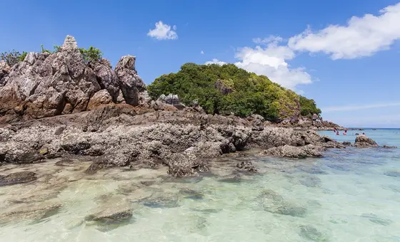 Rocks and clear shallow water on the shore of Khai Nok