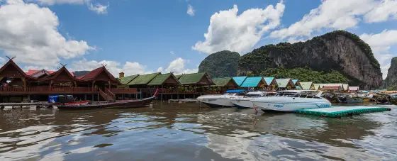 Boats moored at the restaurant piers on Ko Panyi
