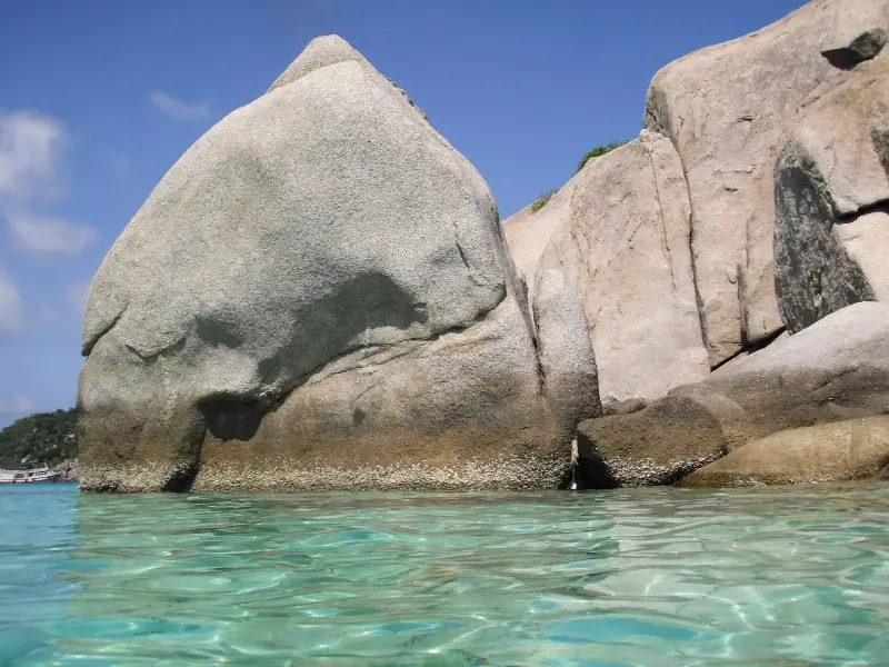 Granite boulders of Nang Yuan above clear turquoise water