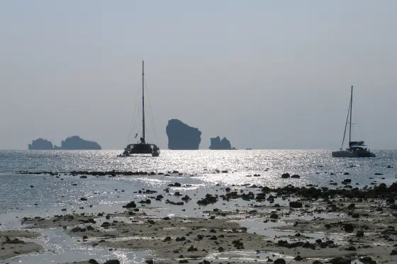 Low tide at Ko Poda: islands of the group on the horizon and two sailing catamarans