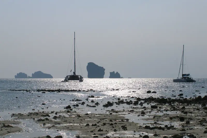 Low tide at Ko Poda: islands of the group on the horizon and two sailing catamarans