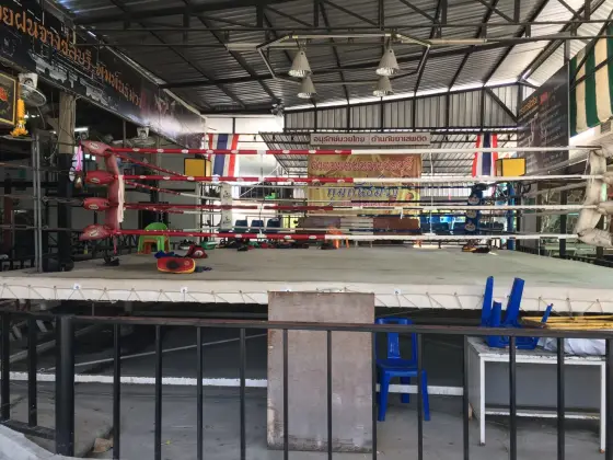 An empty ring and training pads in a Muay Thai gym in Chonburi, an example of a camp setting