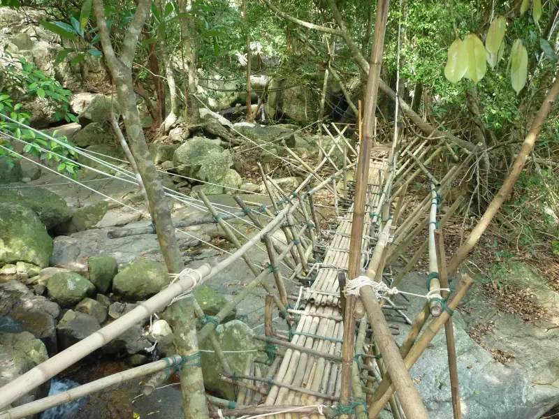 A bamboo footbridge over a stream on the trail to the Na Muang waterfall