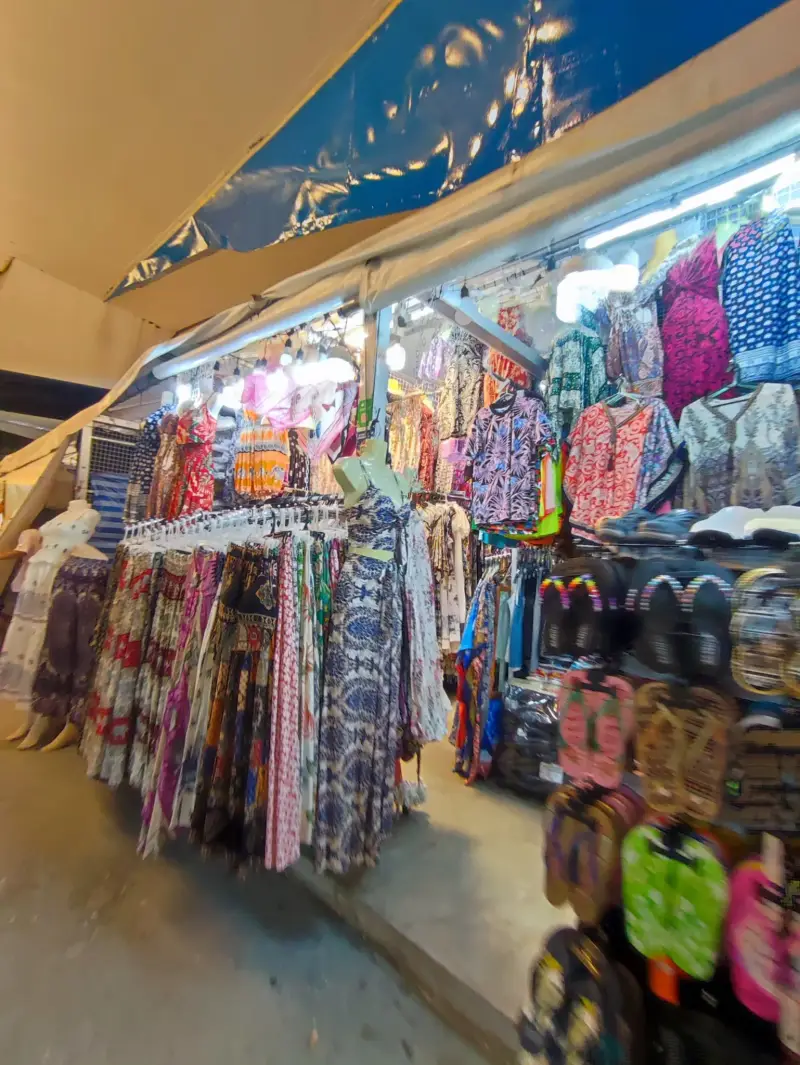 A stall with dresses, shirts and flip-flops at a night market in Pattaya