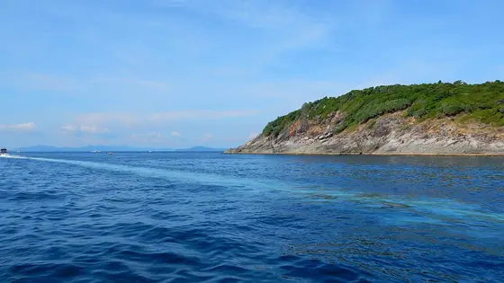 A rocky headland of Racha Yai and the deep blue open sea