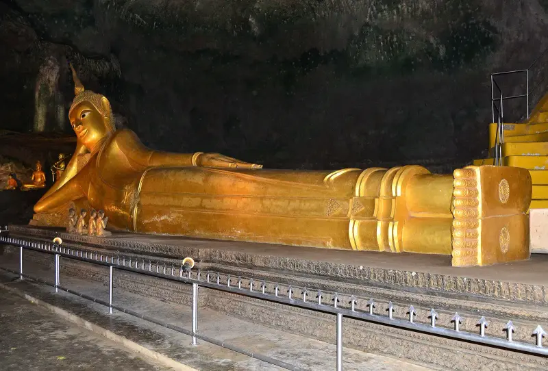 The golden reclining Buddha in the cave of Wat Suwan Kuha in Phang Nga