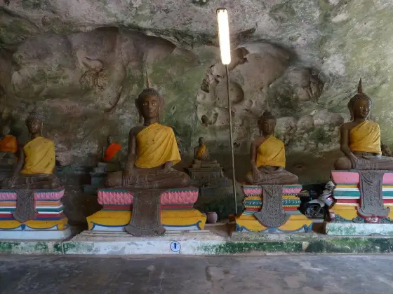 Seated Buddha statues at the entrance of the Suwan Kuha cave